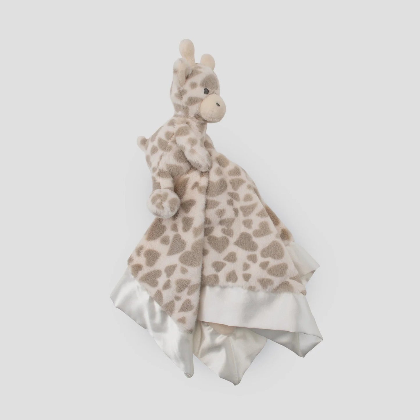 Giraffe-shaped plush toy with a blanket on a light gray background
