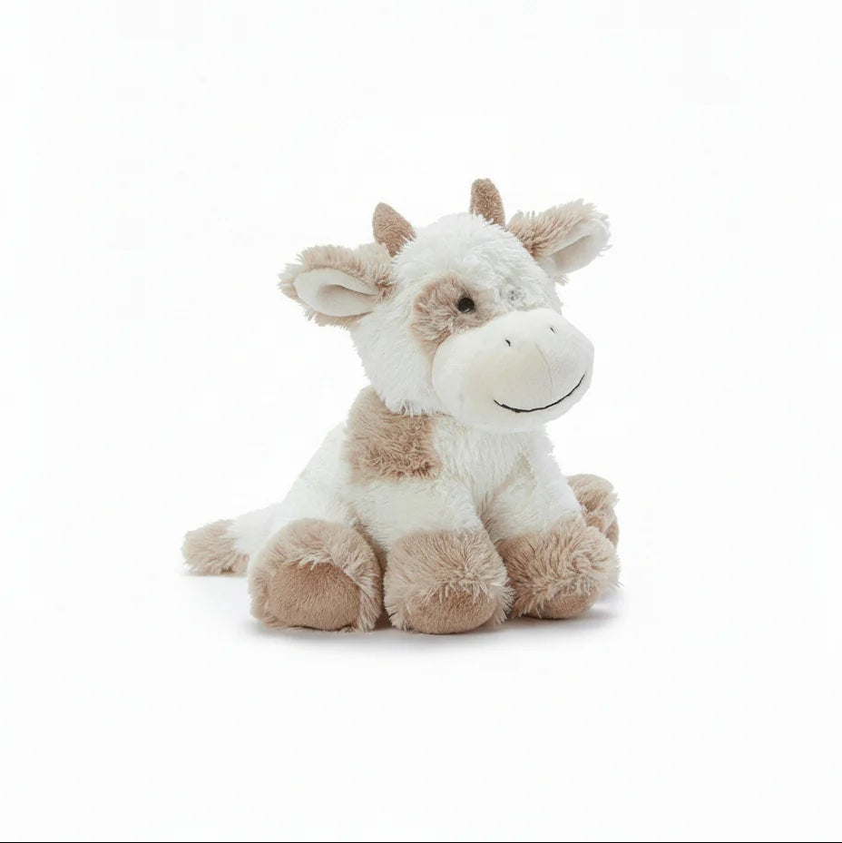 Plush cow toy on a white background