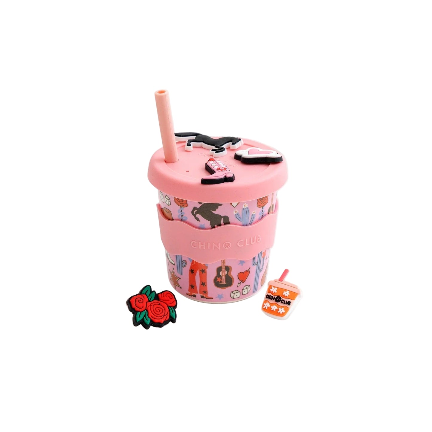 Pink tumbler with straw, small pink cup with design, and decorative pins on a white background