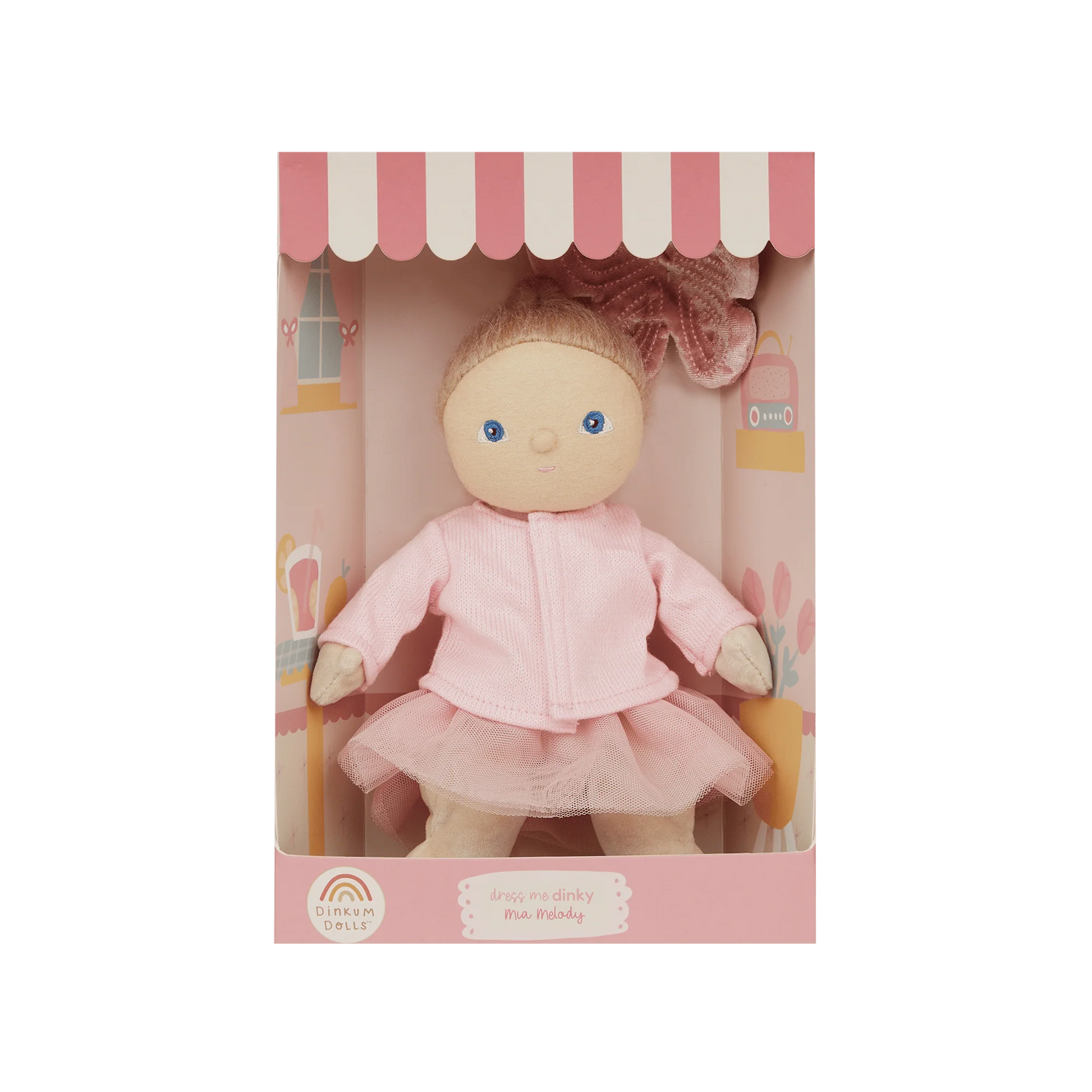 Doll in a pink outfit with a matching box on a white background
