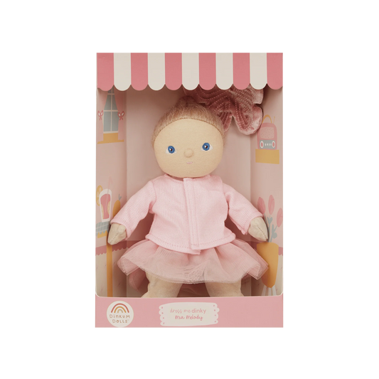 Doll in a pink outfit with a matching box on a white background