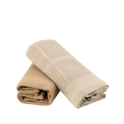 Folded beige blanket on a light gray background