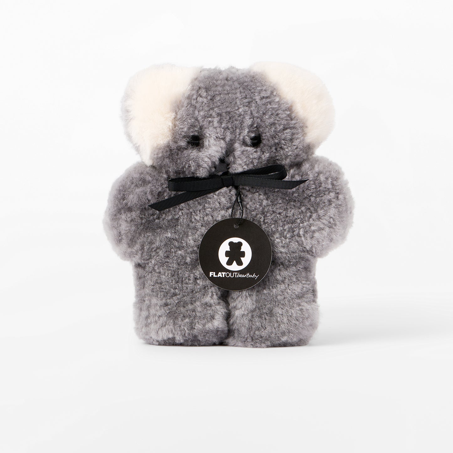 Gray plush bear with a black bow and visible brand logo on a white background