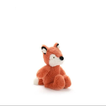 A small plush fox toy in rust orange with a white muzzle, black nose, and black-and-white ears, sitting on a clean white background.