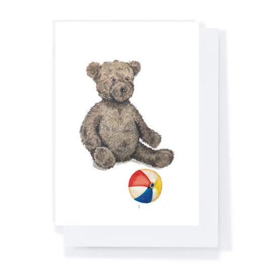 Framed artwork of a teddy bear and a beach ball on a white background