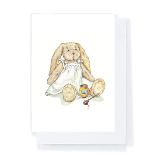 Illustration of a bunny holding a jar of honey and a spoon on a white background