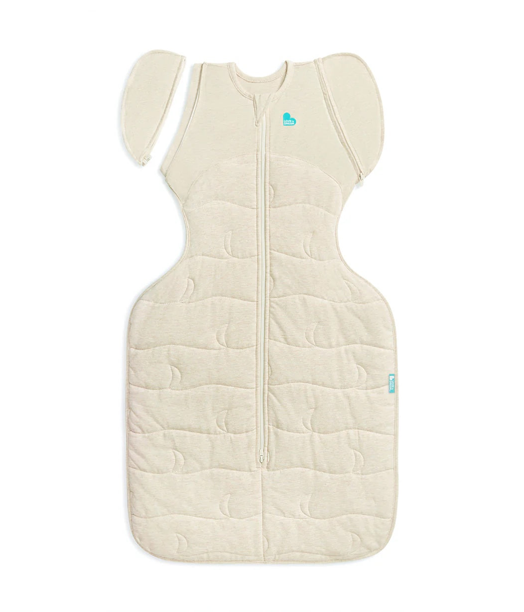 Beige baby sleeping bag with a heart logo on a white background