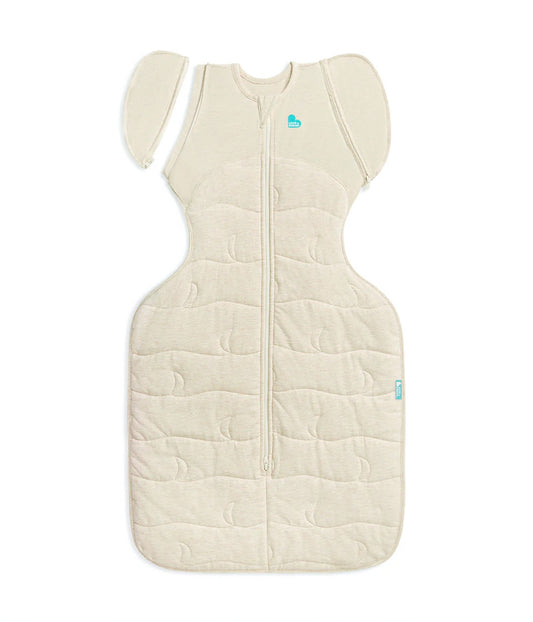 Beige baby sleeping bag with a heart logo on a white background