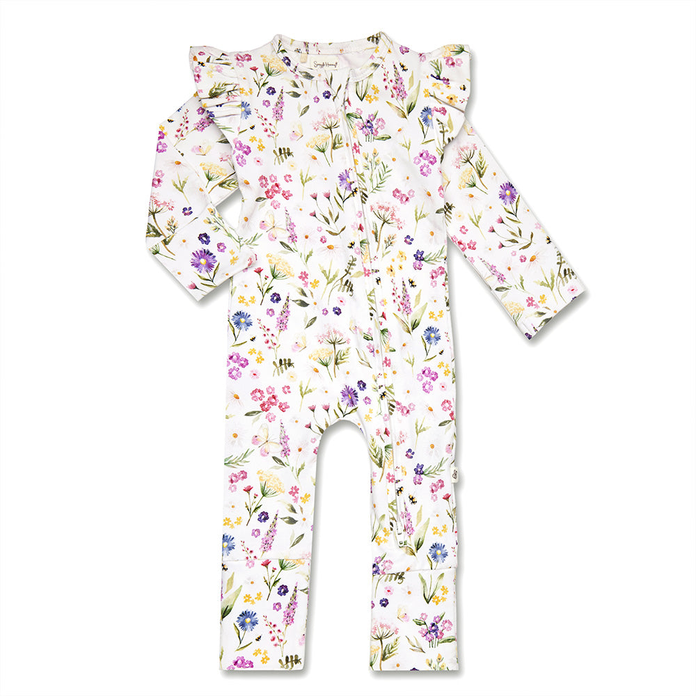 A baby long-sleeve footless one-piece jumpsuit with ruffled shoulder details, featuring a delicate watercolor floral print in pink, purple, green, and yellow on a white background.