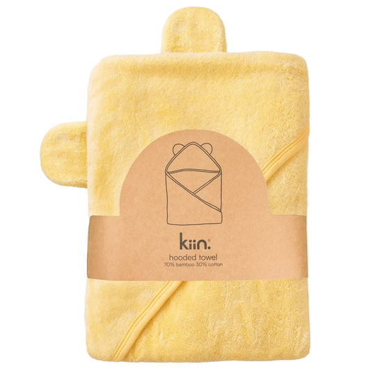 Yellow hooded towel with a matching washcloth on a beige background