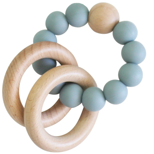 Teething ring with wooden rings and blue silicone beads on a white background