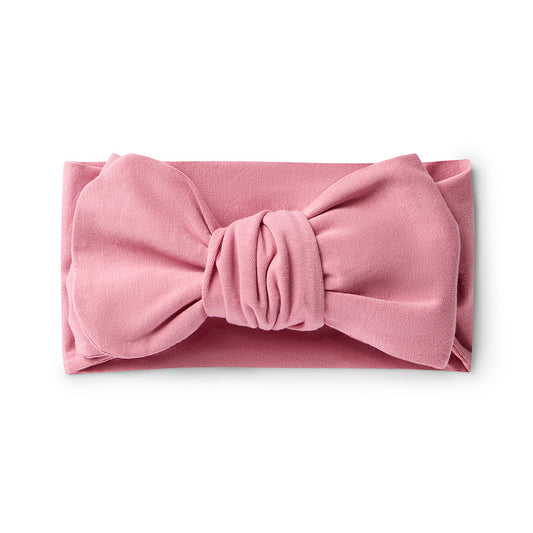 Pink headband with a bow on a white background
