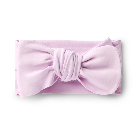 Pink headband with a large bow on a white background