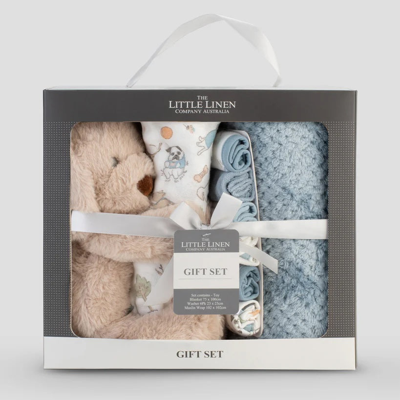 Baby gift set with teddy bear, blanket, and booties in a box labeled 'The Little Linen Company'.