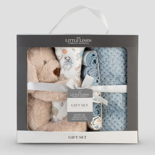 Baby gift set with teddy bear, blanket, and booties in a box labeled 'The Little Linen Company'.
