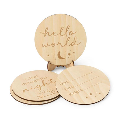 Three wooden discs with engraved text and designs on a white background