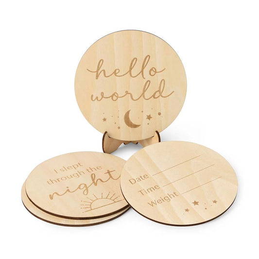 Three wooden discs with engraved text and designs on a white background