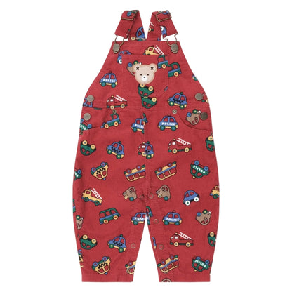 Red children's overalls with vehicle pattern on a beige background