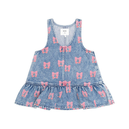 A sleeveless light blue denim dress for toddlers, featuring a pink bow pattern and a ruffled hem, shown flat on a white background.