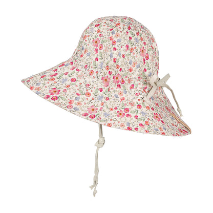 A wide-brimmed sun hat with a dense small floral print on a cream background, featuring a light beige chin cord tied in a bow on the side.