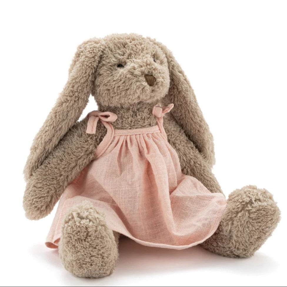 Stuffed bunny toy with a pink dress on a white background