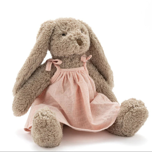 Stuffed bunny toy with a pink dress on a white background