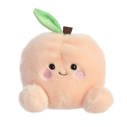 Plush toy shaped like a peach with a smiling face on a white background