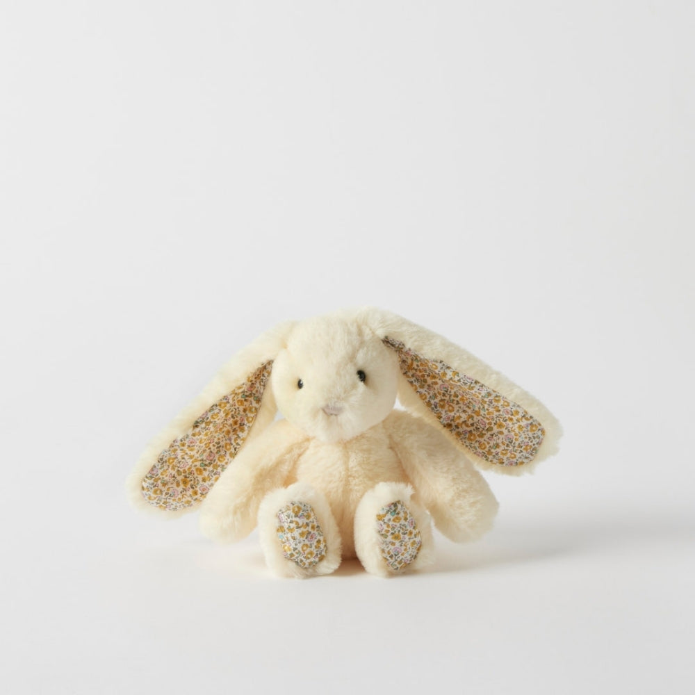 Plush bunny toy with glittery ears and paws on a light gray background