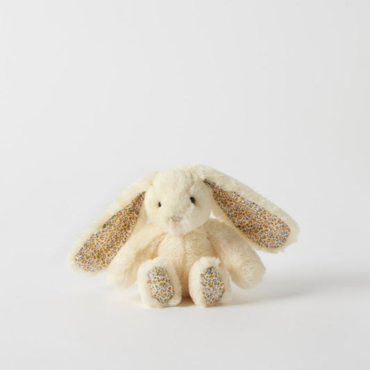 Plush bunny toy with glittery ears and paws on a light gray background