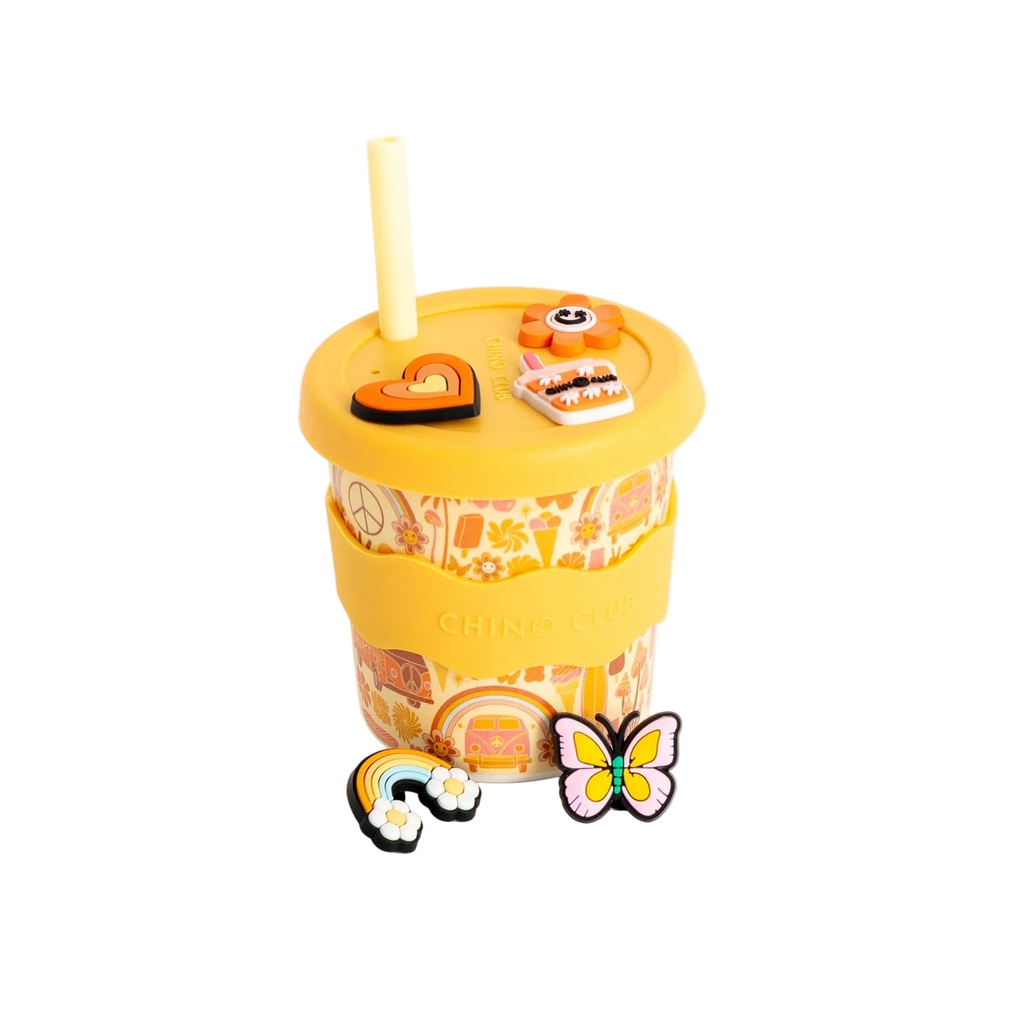 Yellow tumbler with a lid, straw, and decorative charms on a white background