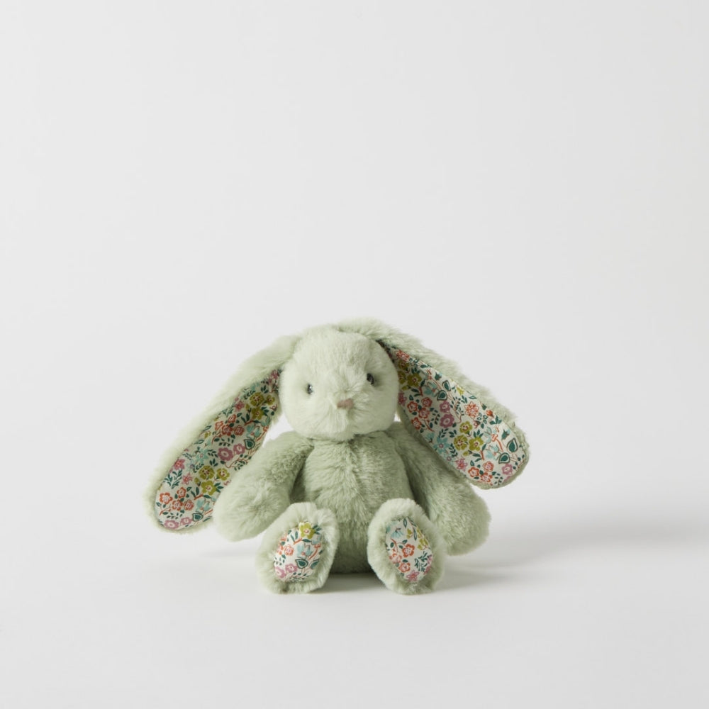 Green plush bunny with floral ears on a light gray background