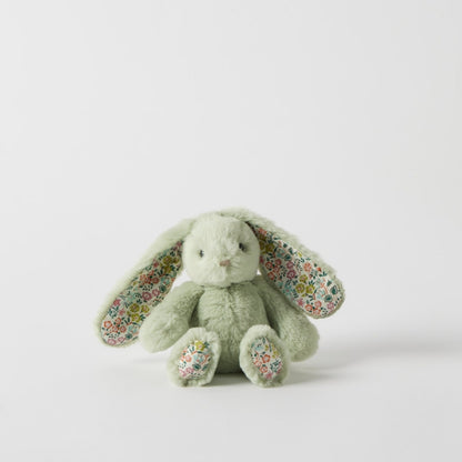Green plush bunny with floral ears on a light gray background