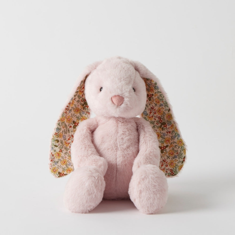 Pink plush bunny with floral ears on a white background