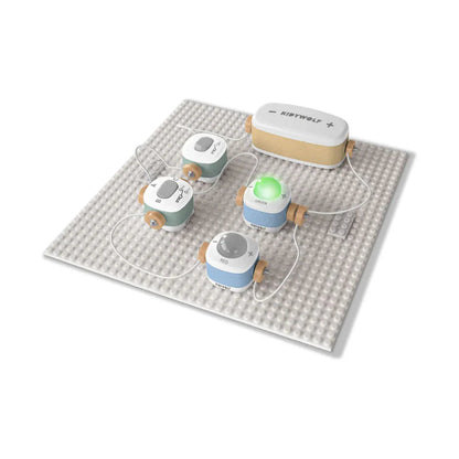 Set of small round devices with charging cables on a textured mat