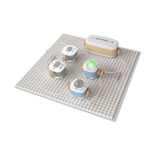 Set of small round devices with charging cables on a textured mat