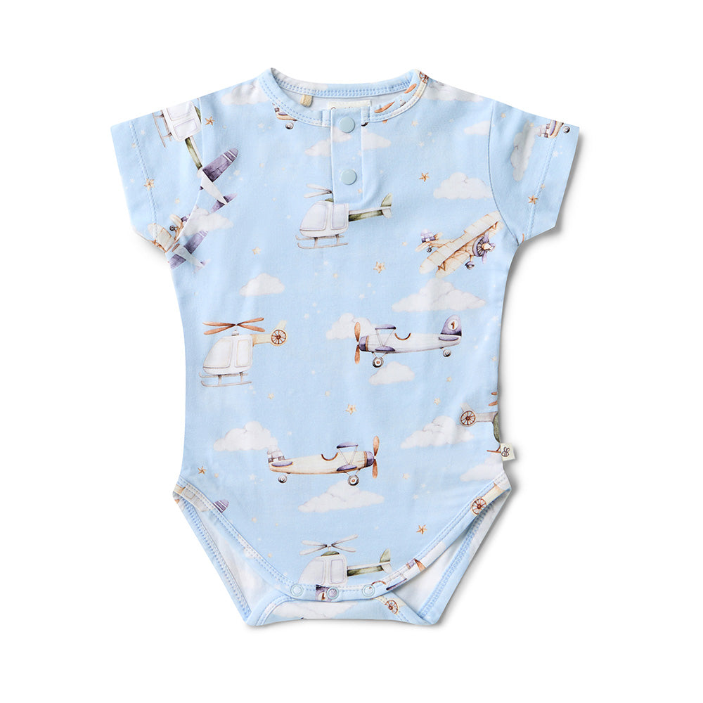 Baby onesie with airplane pattern on a light blue background