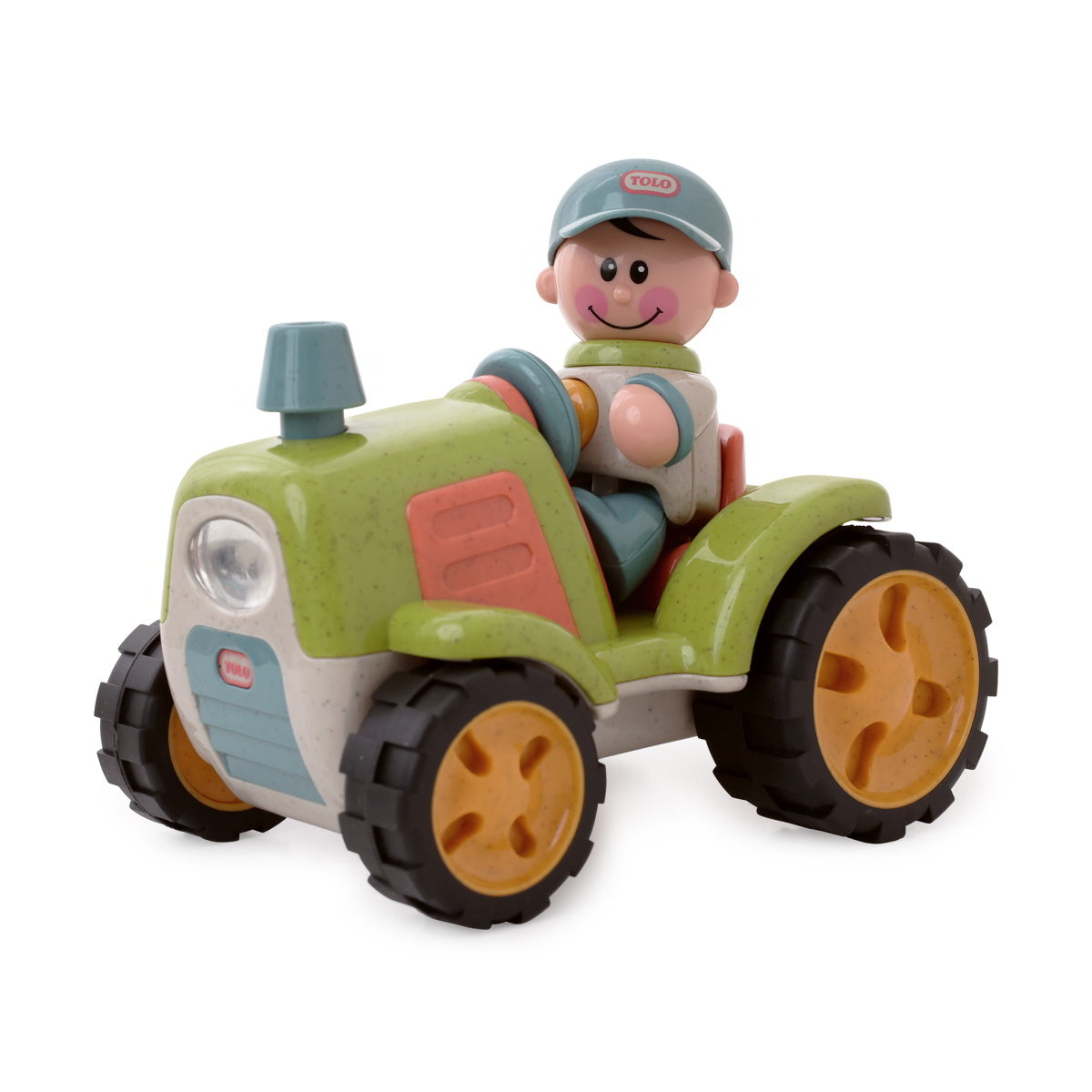 Toy tractor with a figurine of a boy on a white background