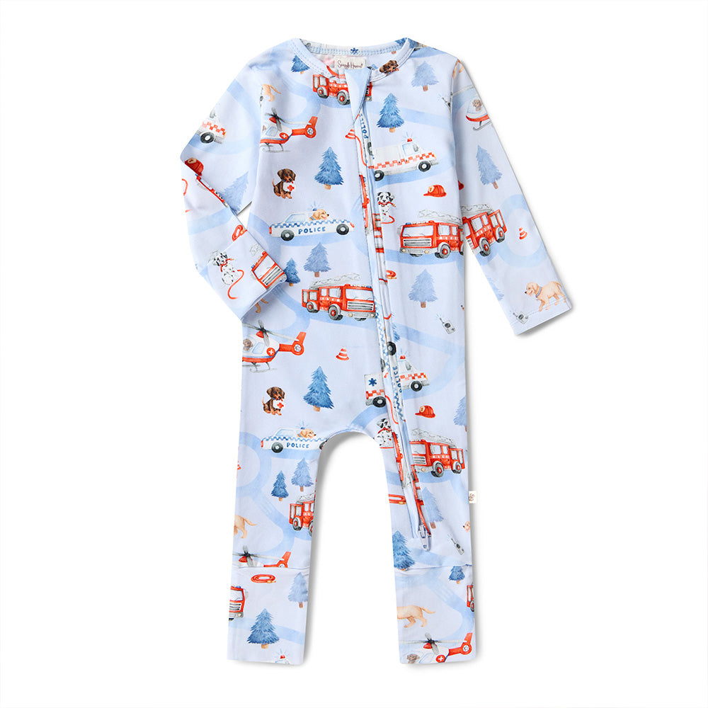 Children's onesie with fire truck and airplane pattern on a light blue background