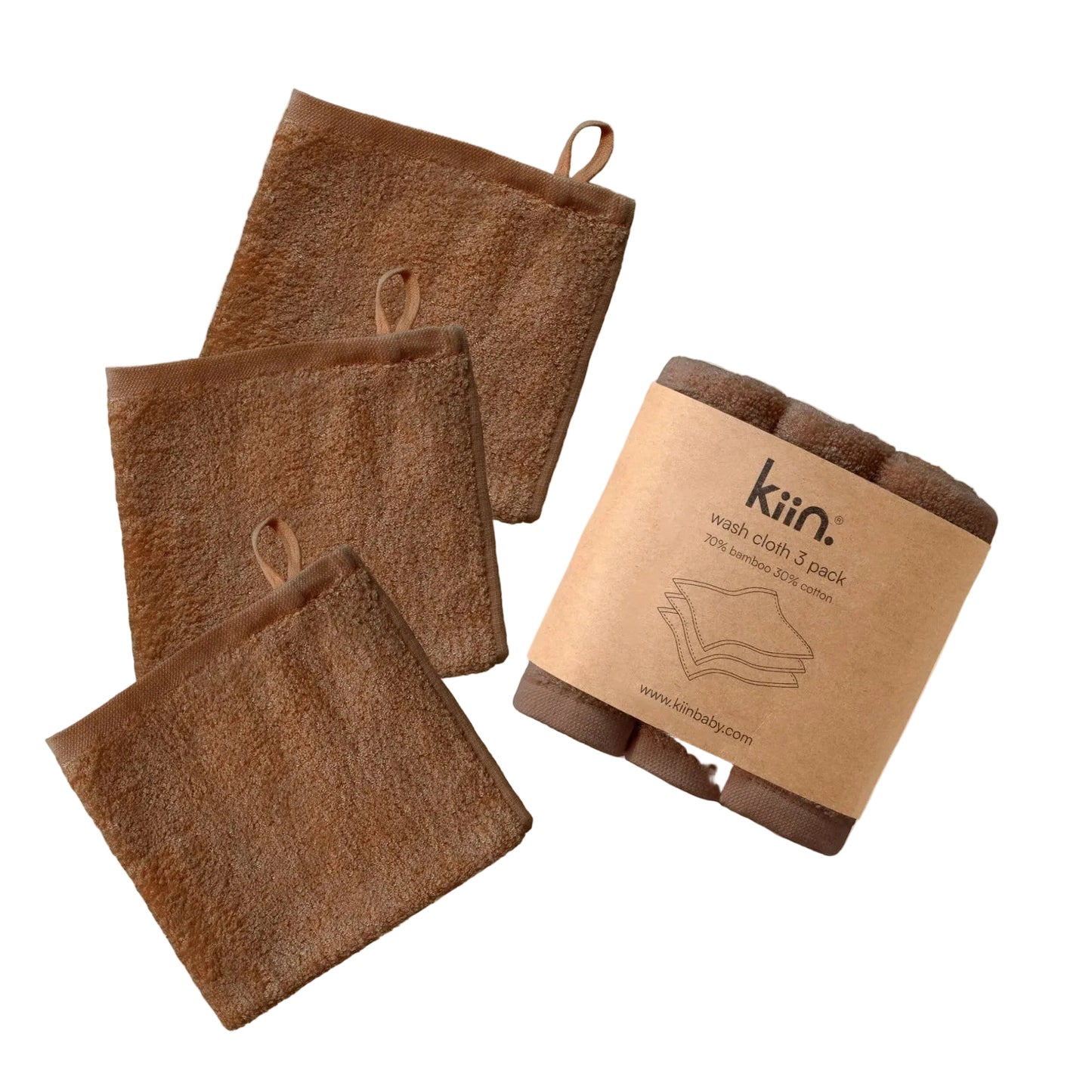 Three brown towels with a cardboard packaging on a beige background