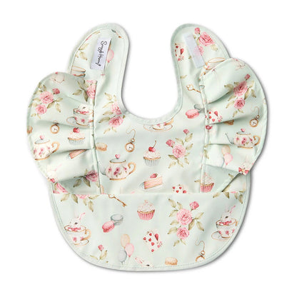 Baby bib and hat set with floral and tea party design on a white background